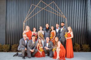 Wedding party in front of storehouse wall