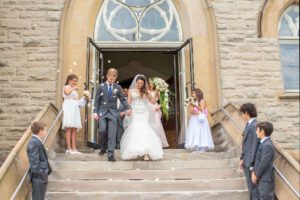 bride and groom leaving the church after ceremony