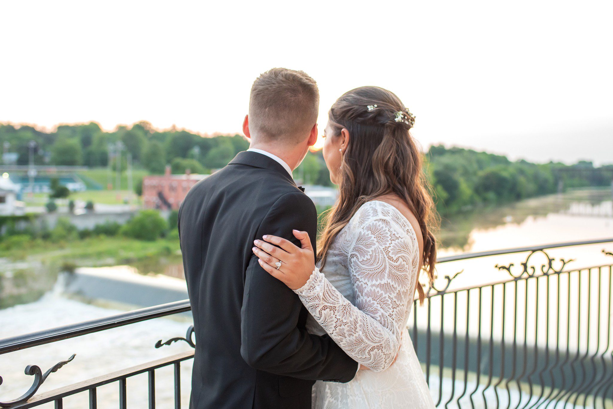 Bride and Groom looking over the water at Cambridge Mill