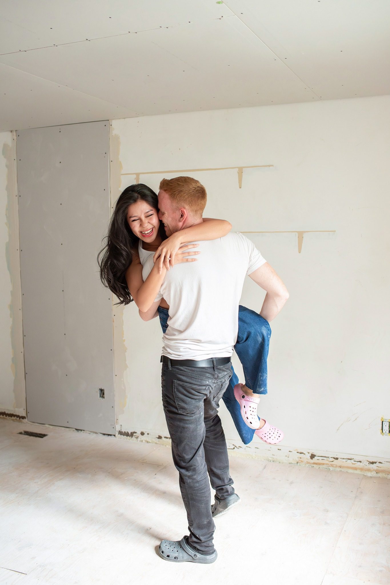 Couple cuddling in their home under renovations