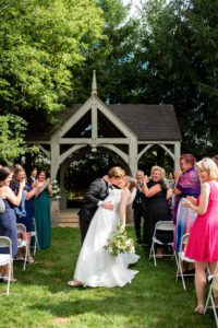 Bride and groom kissing in the middle of the aisle at Bellamere Winery and Event Centre.