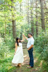 Man spinning woman in the trees at Fanshawe Conservation Area.