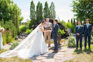 Bride and groom laughing during their ceremony at Hessenland Inn.