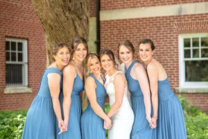 Bride and Bridesmaids smiling at camera at Ivey Spencer Leadership Centre.