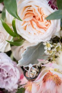 Wedding rings in pink and purple bouquet at Bellamere Winery.
