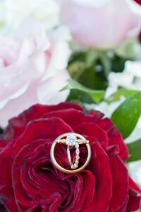 Wedding Rings on red, white and pink bouquet at FireRock.