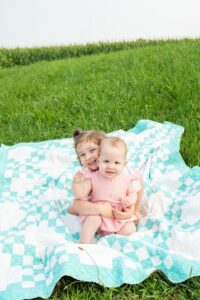 Little girl hugging her younger sister