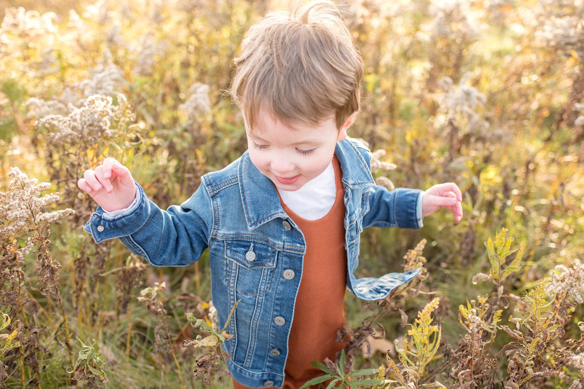 boy in fall tall grass