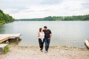 couple walking together in front of water