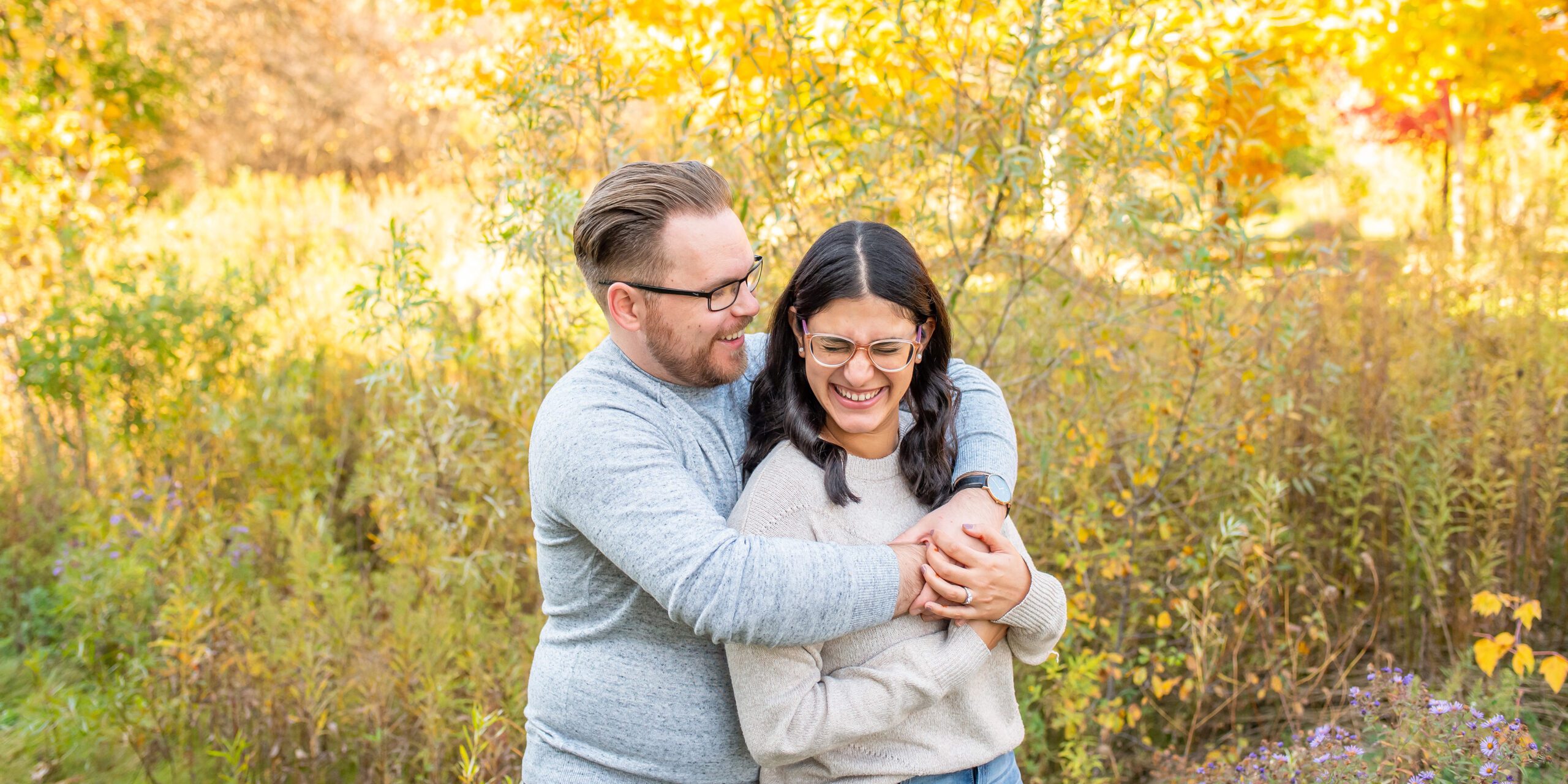 Couple snuggling at Fanshawe Conservation Area.