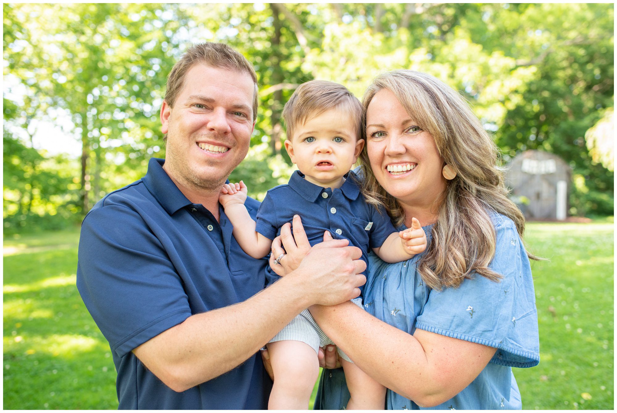 Parents holding young son in between them at Civic Gardens