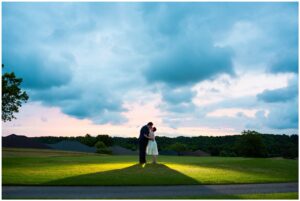 Bride and Groom backlit with blue and pink sky at Riverbend Golf Community.