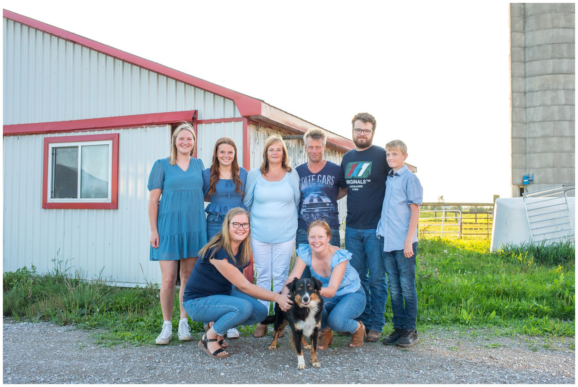 Family together on their farm with their dog
