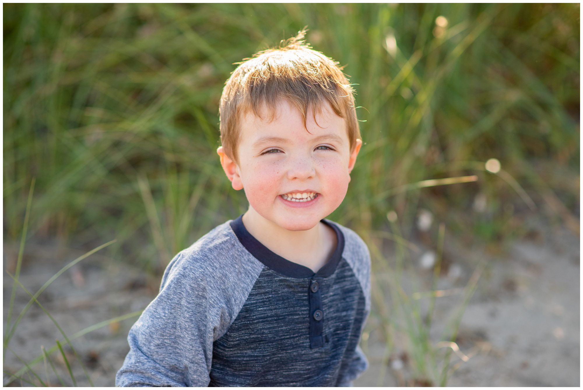 little boy smiling on the beach in Port Stanley Ontario