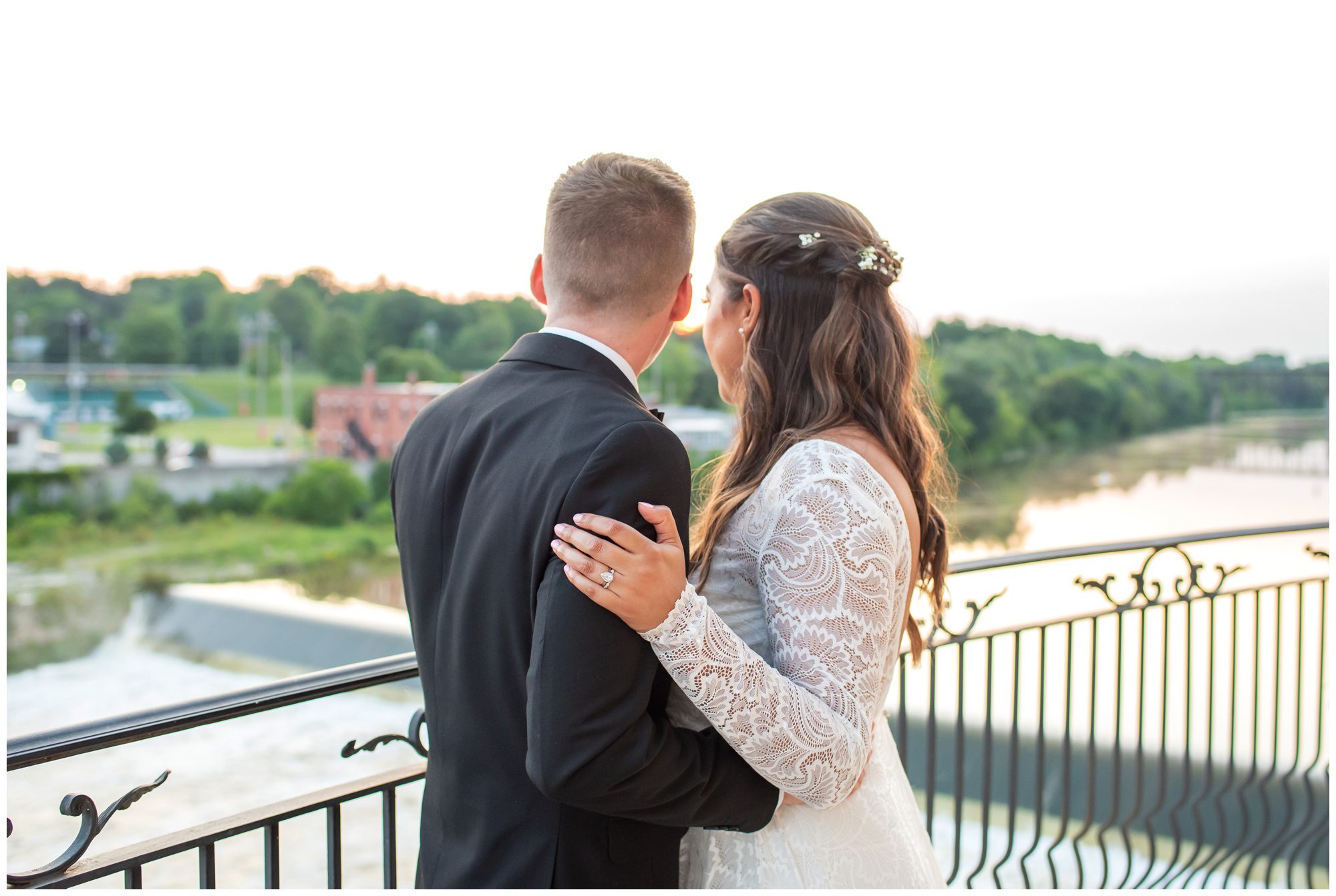 Bride and Groom looking out over the water at Cambridge Mill