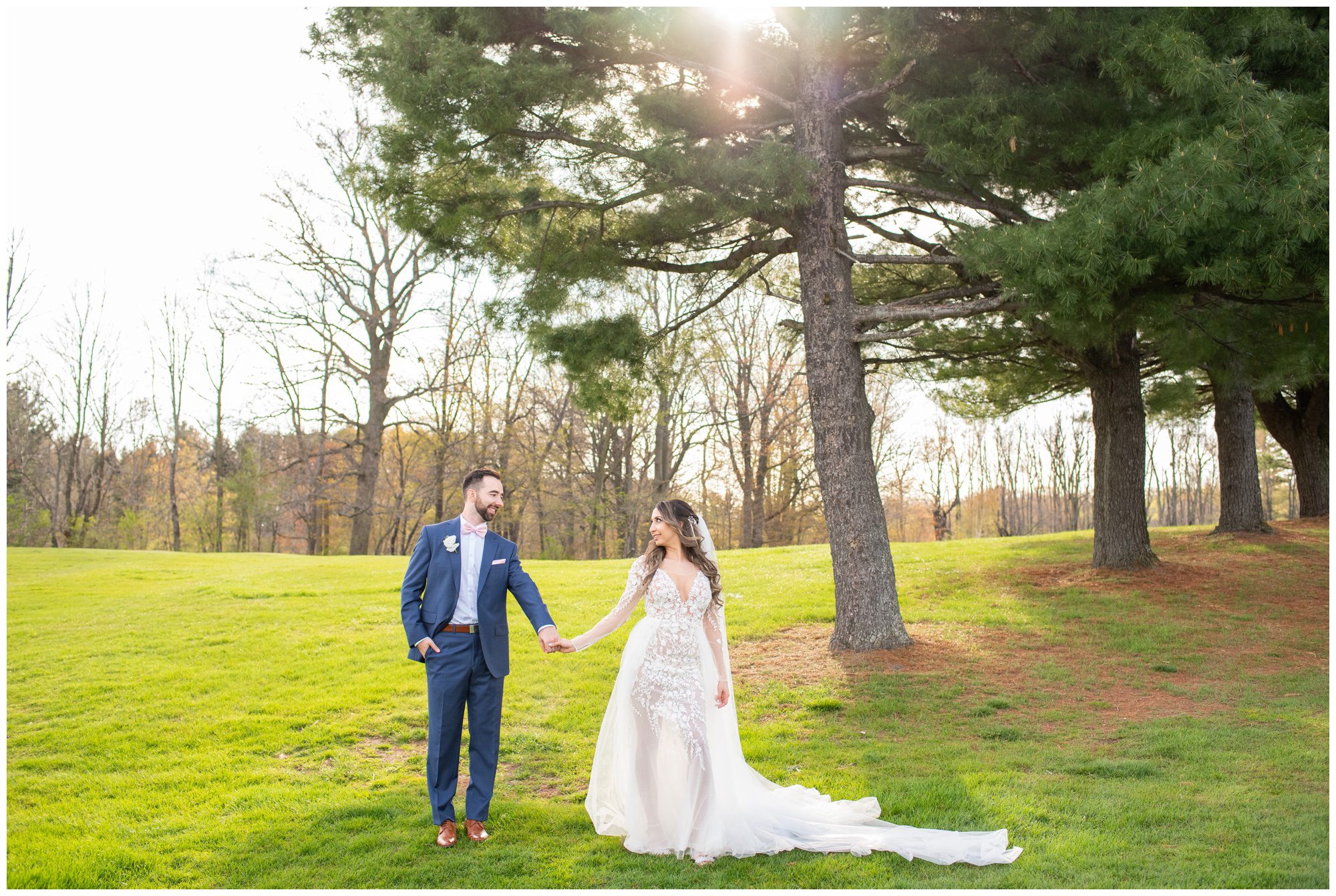 Bride and groom standing hand in hand on the Flamborough Hills Golf Course.