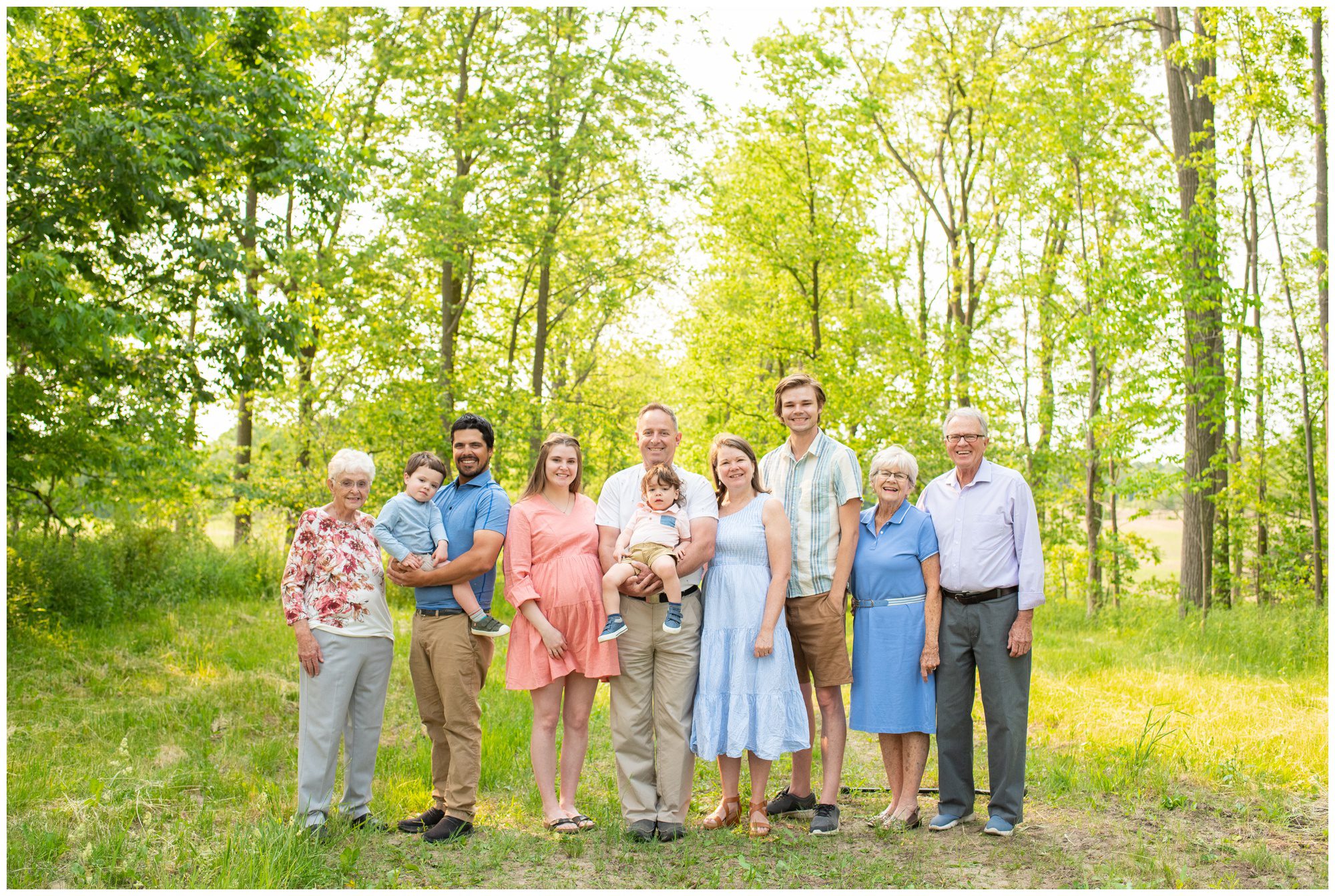 Family standing together on tree lined path