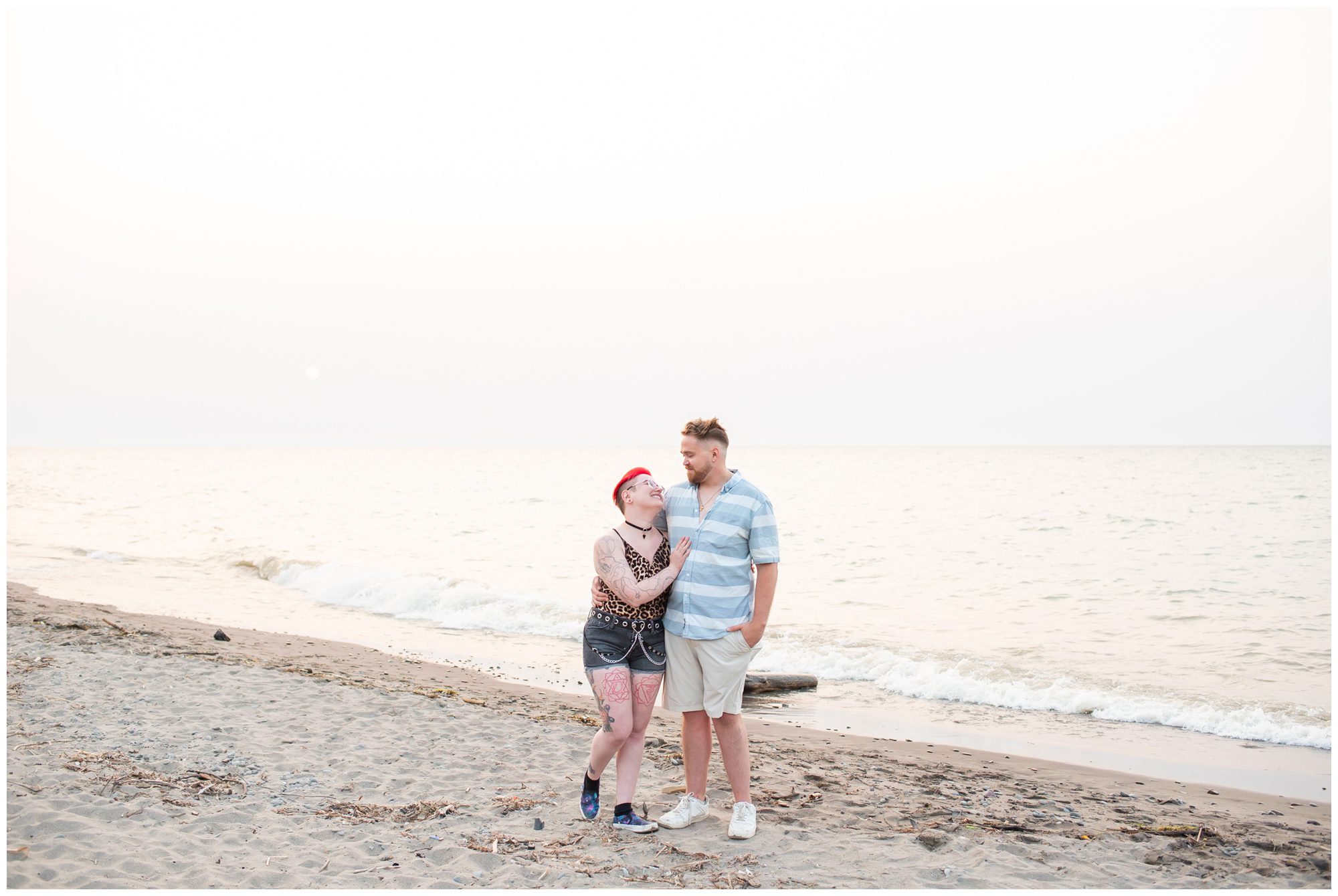 Couple standing on the beach at sunset at Charles Daley Park.