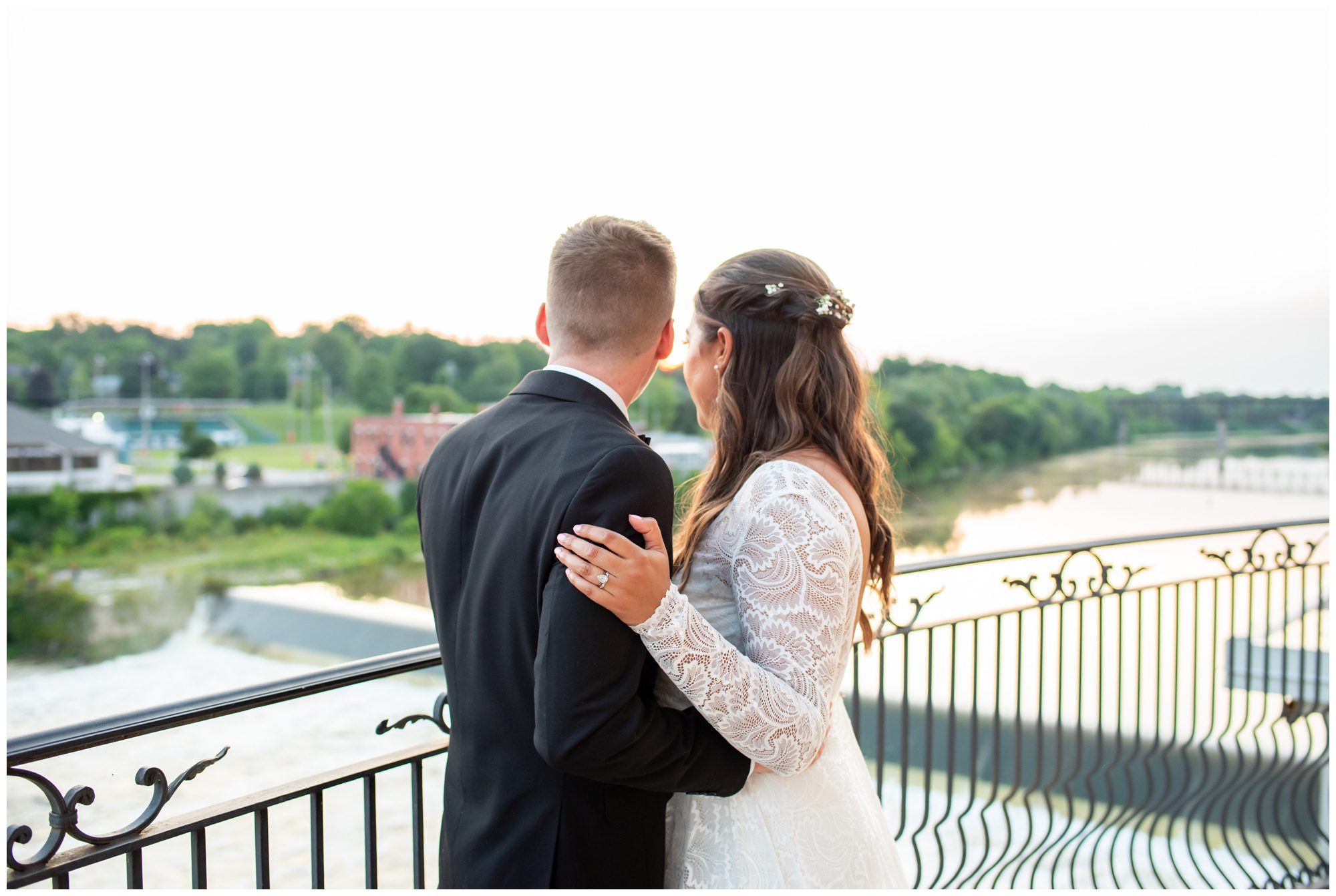 Bride and groom looking over a balcony at Cambridge Mill