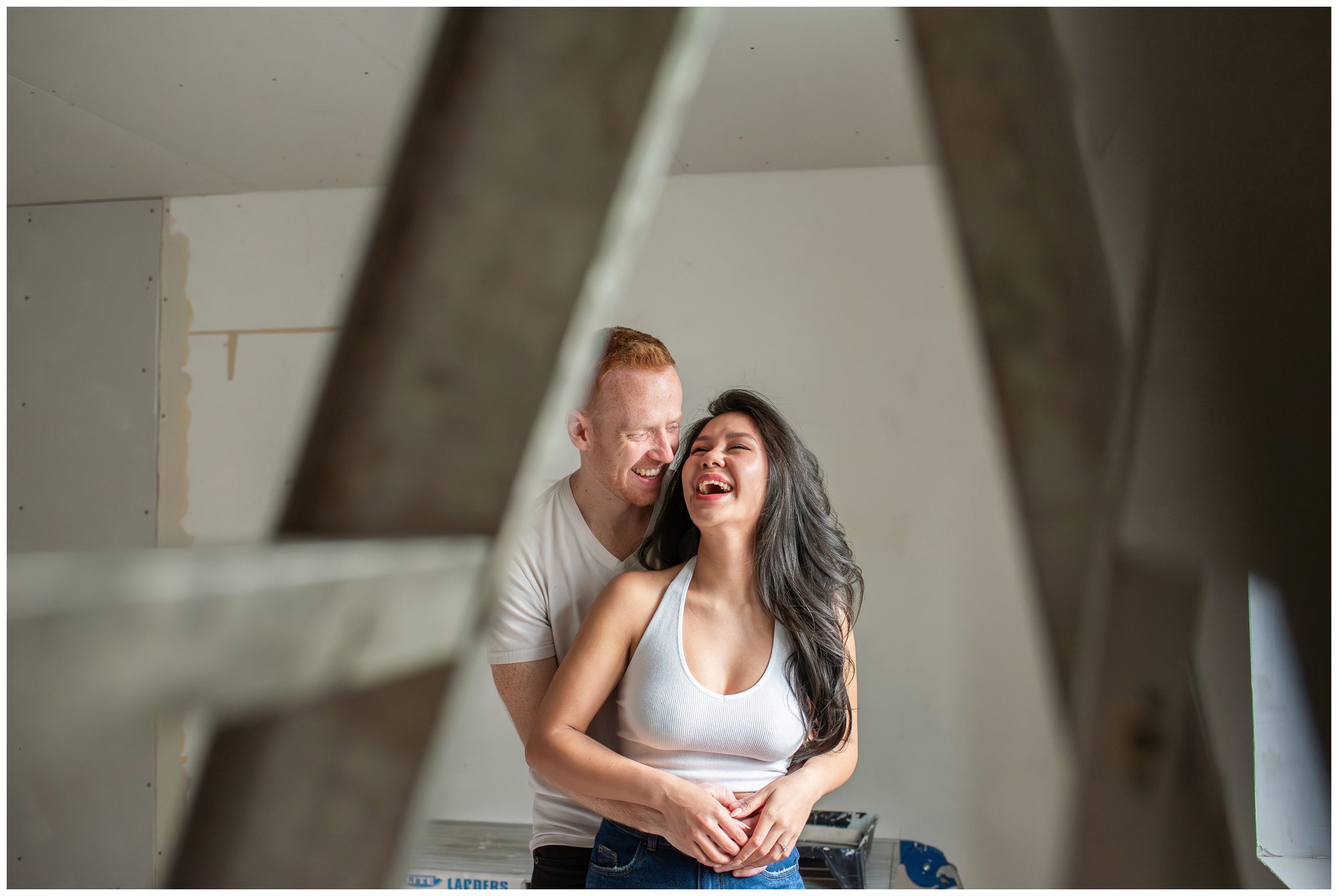 Couple laughing together in their home while renovating in London Ontario