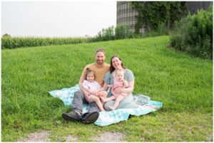 Family of four sitting together on their family farm.