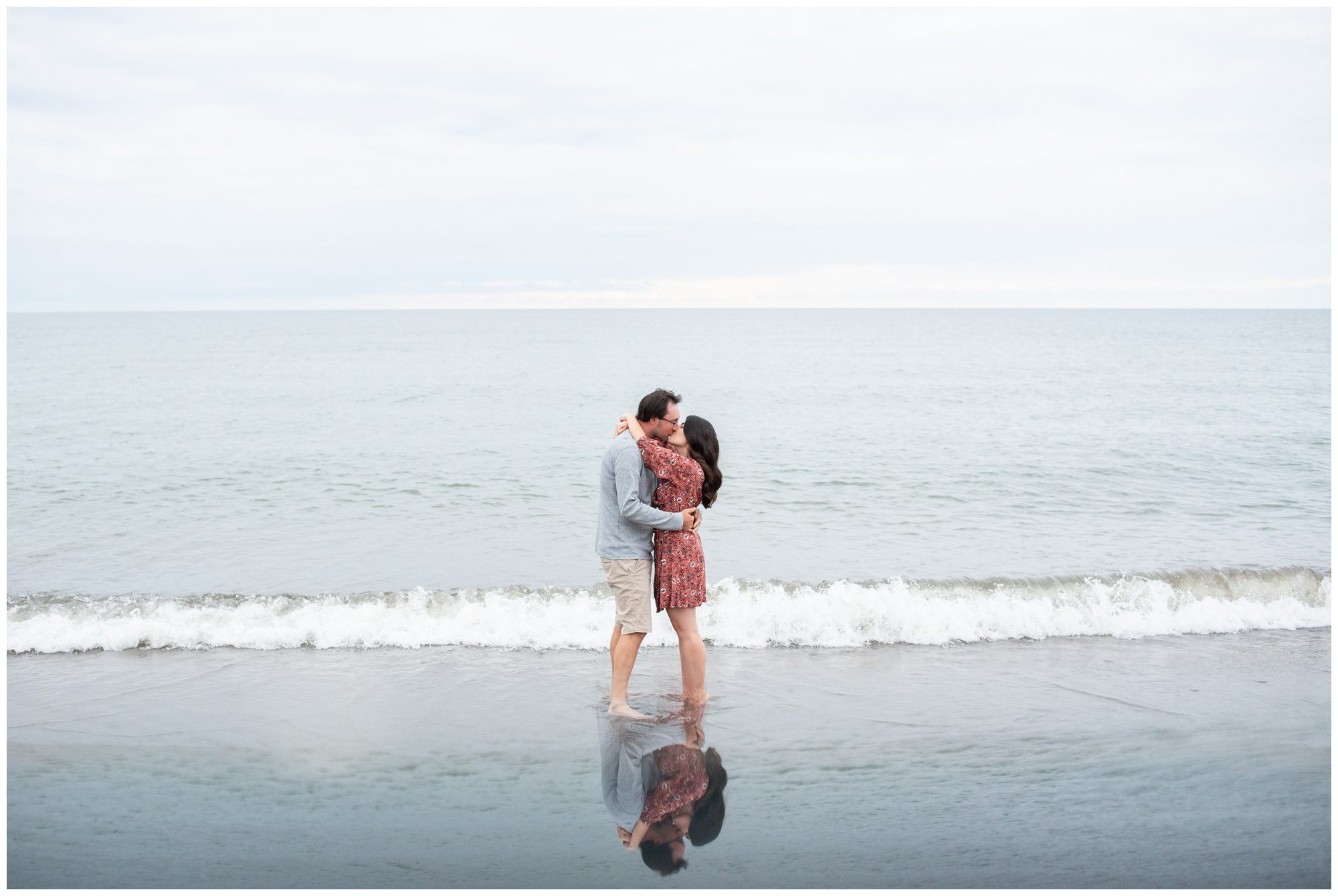 Couple kissing in front of Lake Erie at Rondeau Provincial Park.