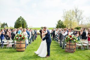Bride and groom kissing at the end of the aisle at Sprucewood Shores Estate Winery in Amherstburg Ontario