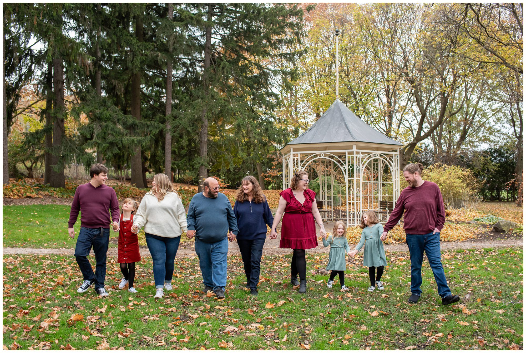 Extended family walking hand in hand at Shakespearean Gardens Stratford.