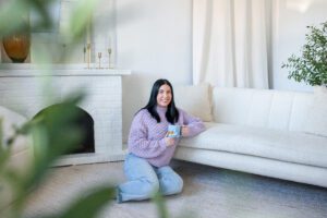 Michelle of Michelle A Photography smiling at camera with corgi mug.