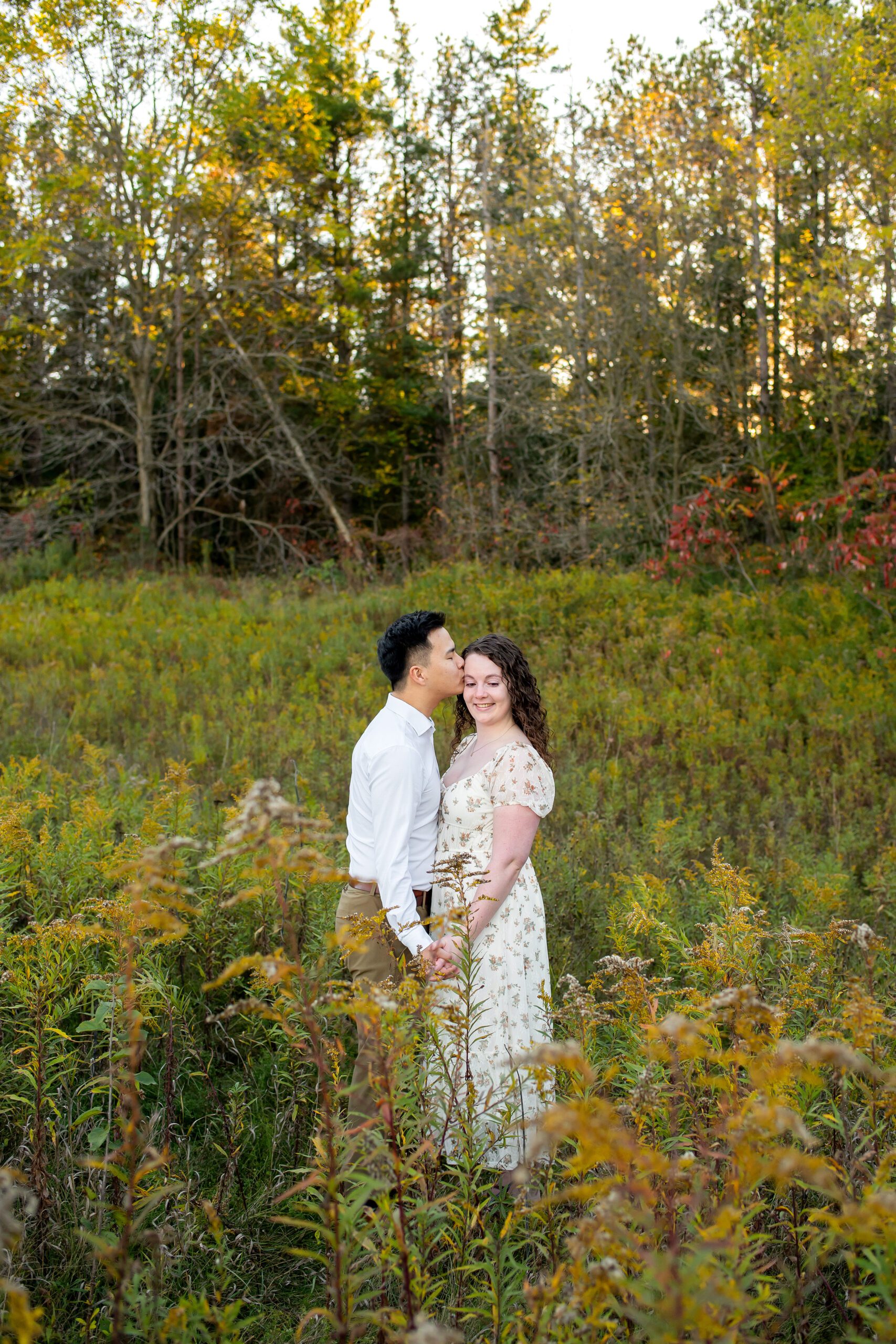 Couple in a field at Lakeside Park in Kitchener Ontario.