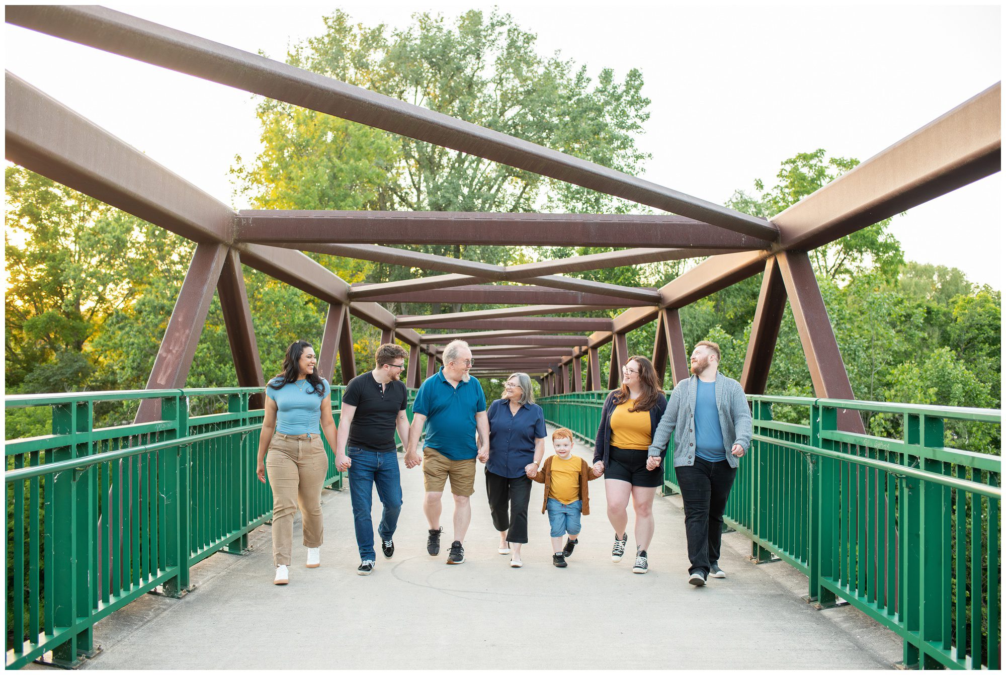 Extended family walking down a bridge at Springbank Park in London Ontario.