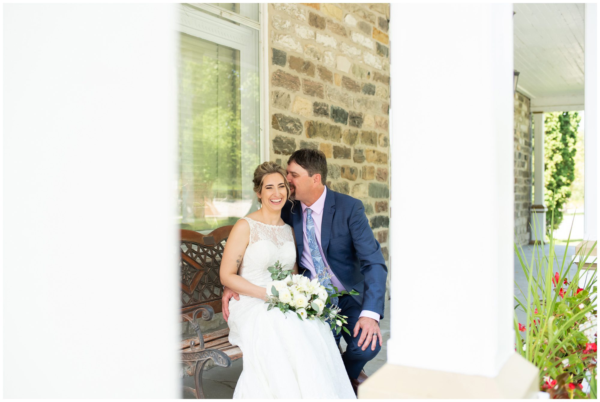 Groom kissing bride on cheek at Beachville District Museum in Beachville Ontario.