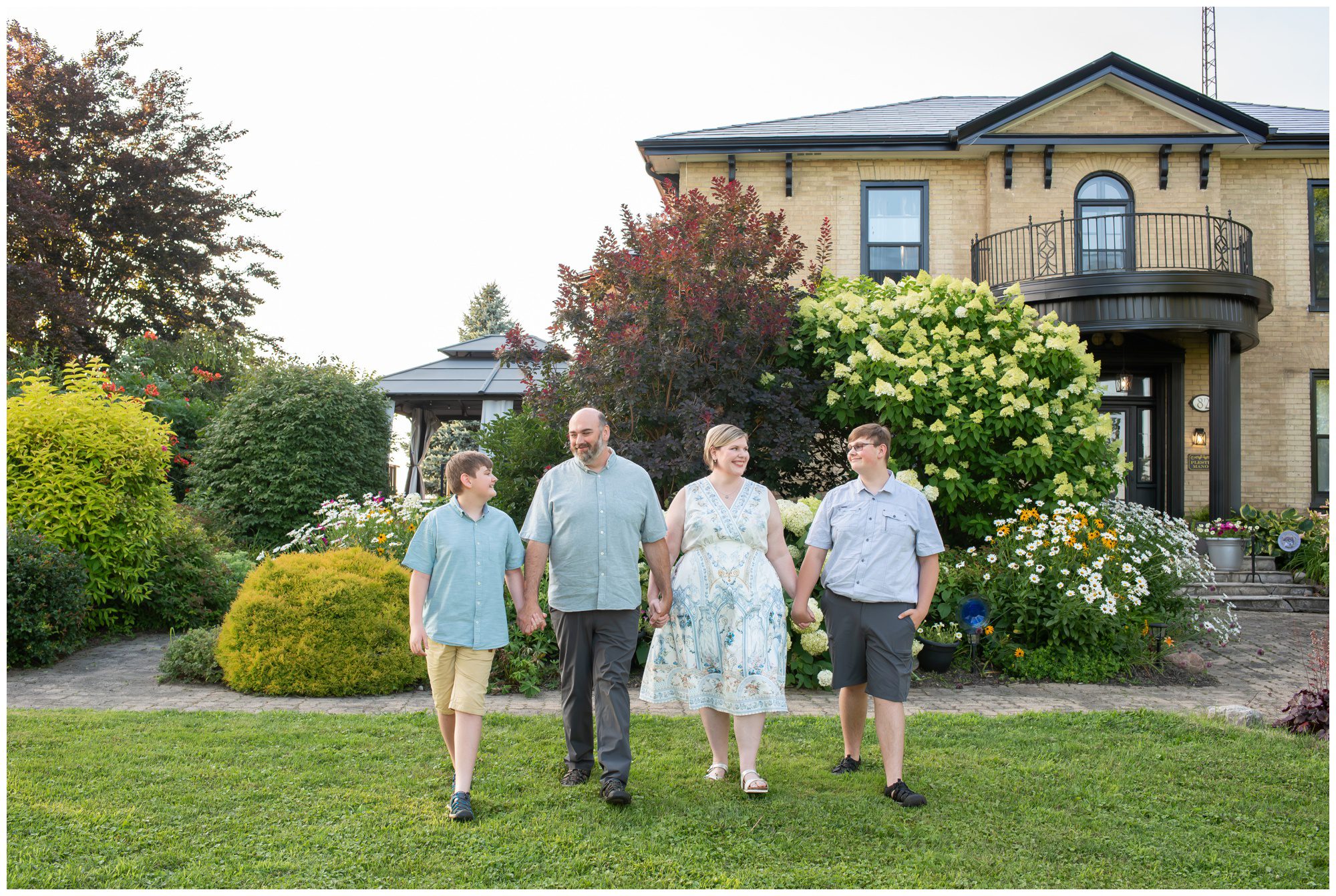 Family walking together in front of their home in Princeton Ontario.