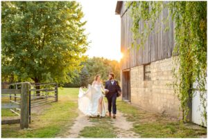 Bride and groom running towards the camera at golden hour at Quiet Earth in Dorchester Ontario.