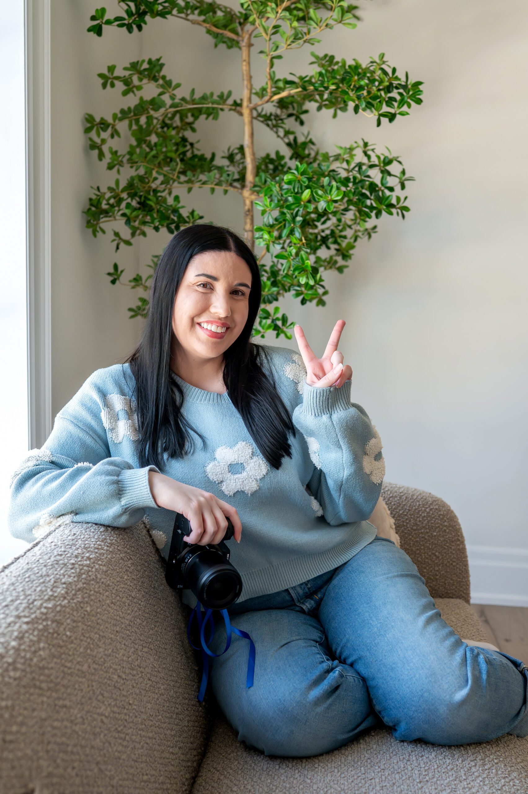Michelle of Michelle A Photography holding a camera at Lumen House in London Ontario