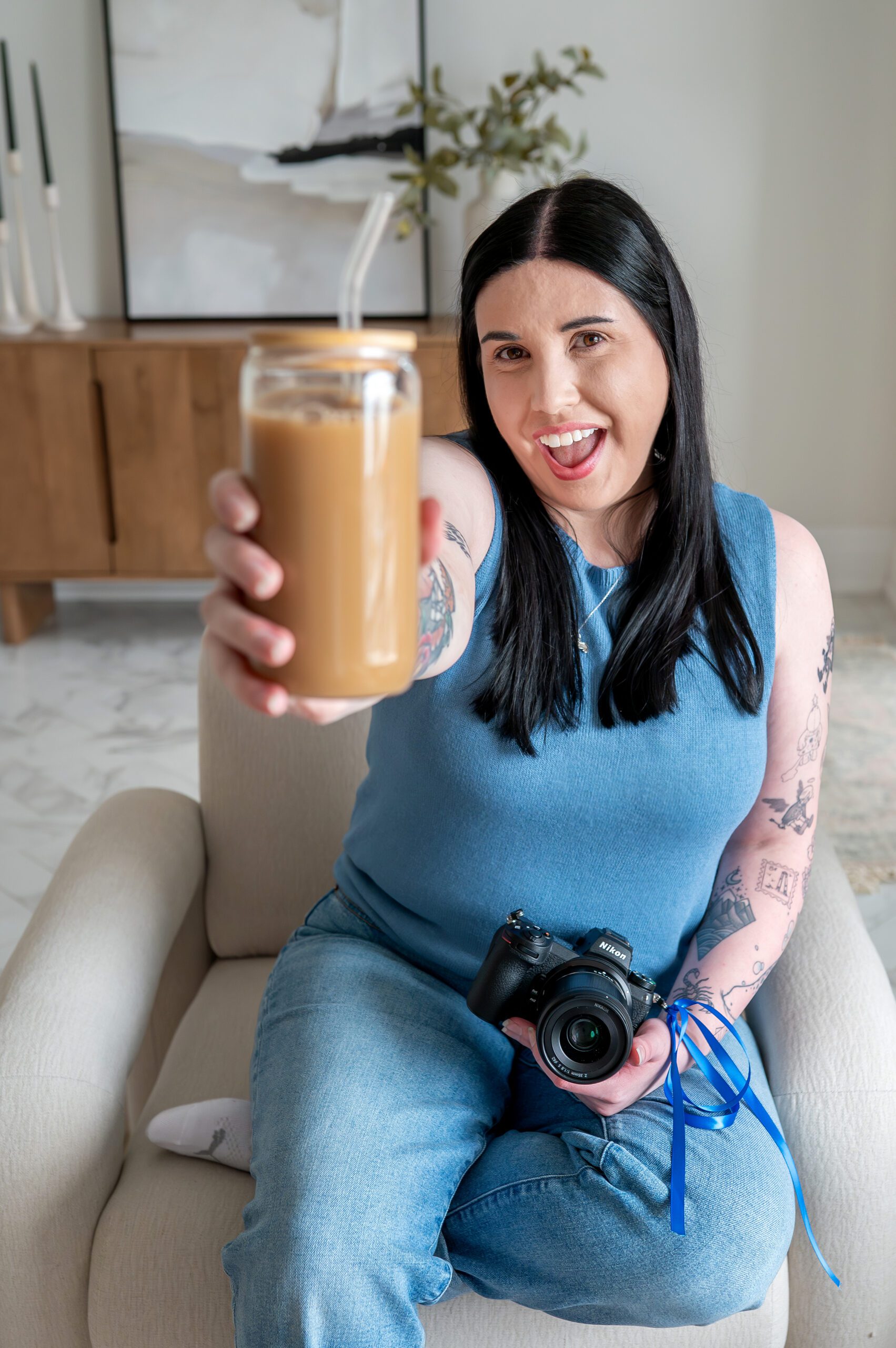 Michelle of Michelle A Photography holding an iced coffee at Lumen House in London Ontario